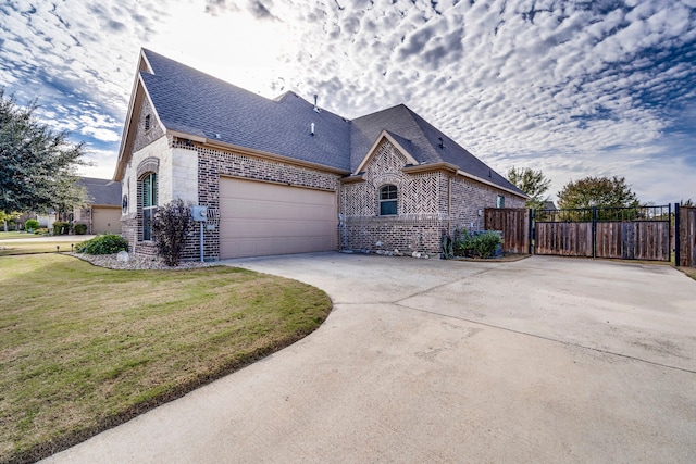 view of property exterior featuring a lawn and a garage