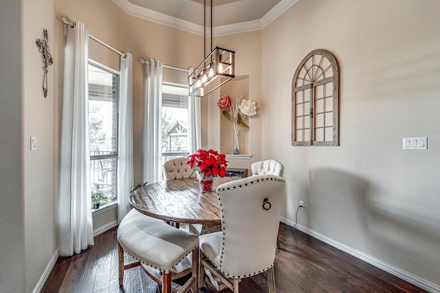 dining area featuring ornamental molding and dark wood-type flooring