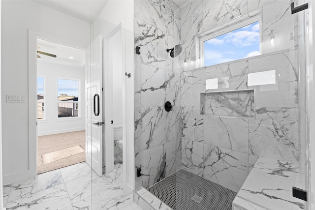 bathroom featuring a tile shower, ceiling fan, and toilet