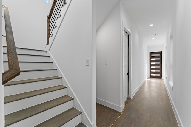 staircase with hardwood / wood-style floors