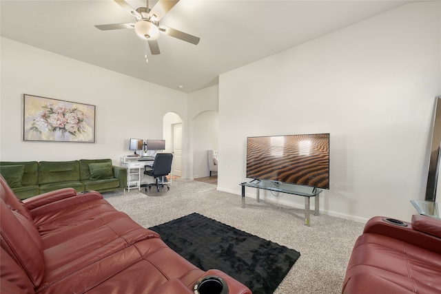 carpeted living room featuring ceiling fan and vaulted ceiling