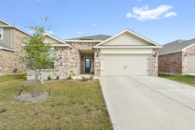 view of front of home featuring a garage and a front yard