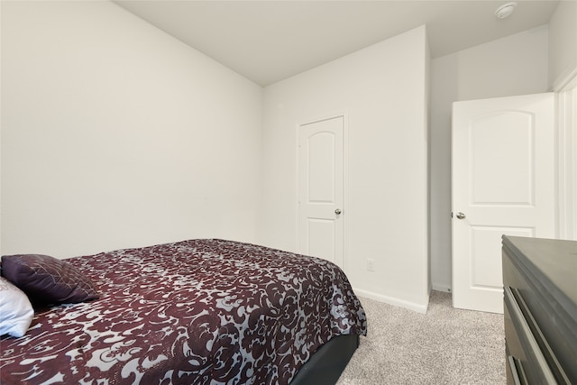 carpeted bedroom featuring vaulted ceiling