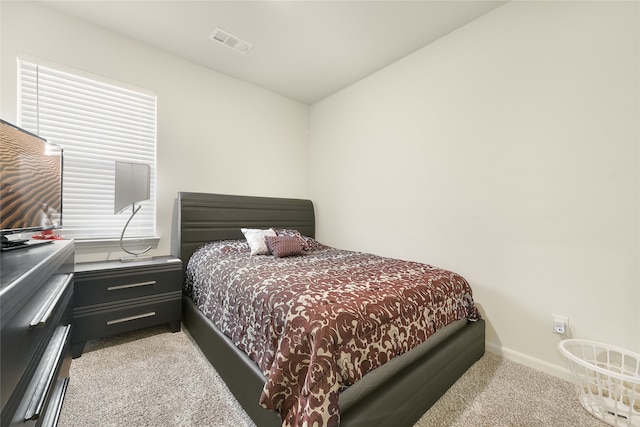 bedroom with light colored carpet