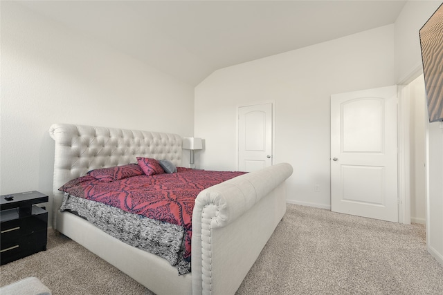 bedroom with carpet flooring and lofted ceiling