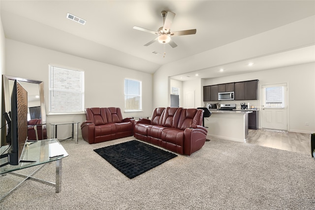 living room featuring light hardwood / wood-style floors, ceiling fan, and lofted ceiling