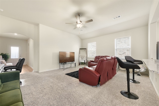 living room featuring ceiling fan, plenty of natural light, light colored carpet, and lofted ceiling