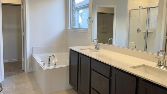 bathroom featuring independent shower and bath, tile patterned floors, and vanity