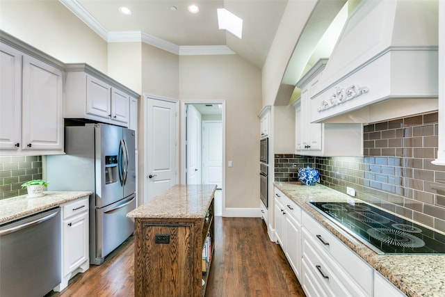 kitchen with light stone countertops, appliances with stainless steel finishes, dark hardwood / wood-style flooring, and tasteful backsplash