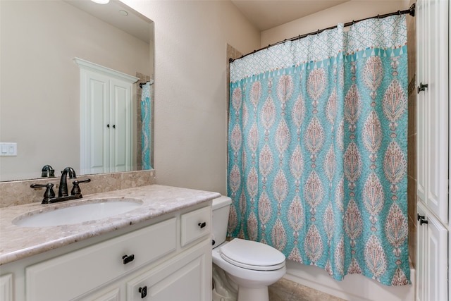 full bathroom with tile patterned floors, vanity, toilet, and shower / bath combo with shower curtain