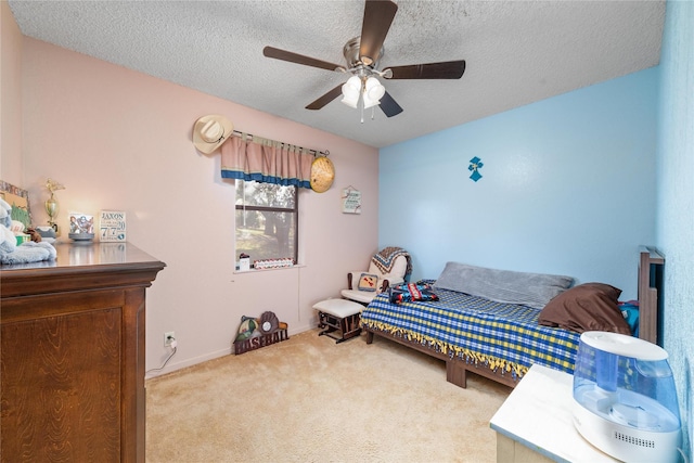 carpeted bedroom with a textured ceiling and ceiling fan