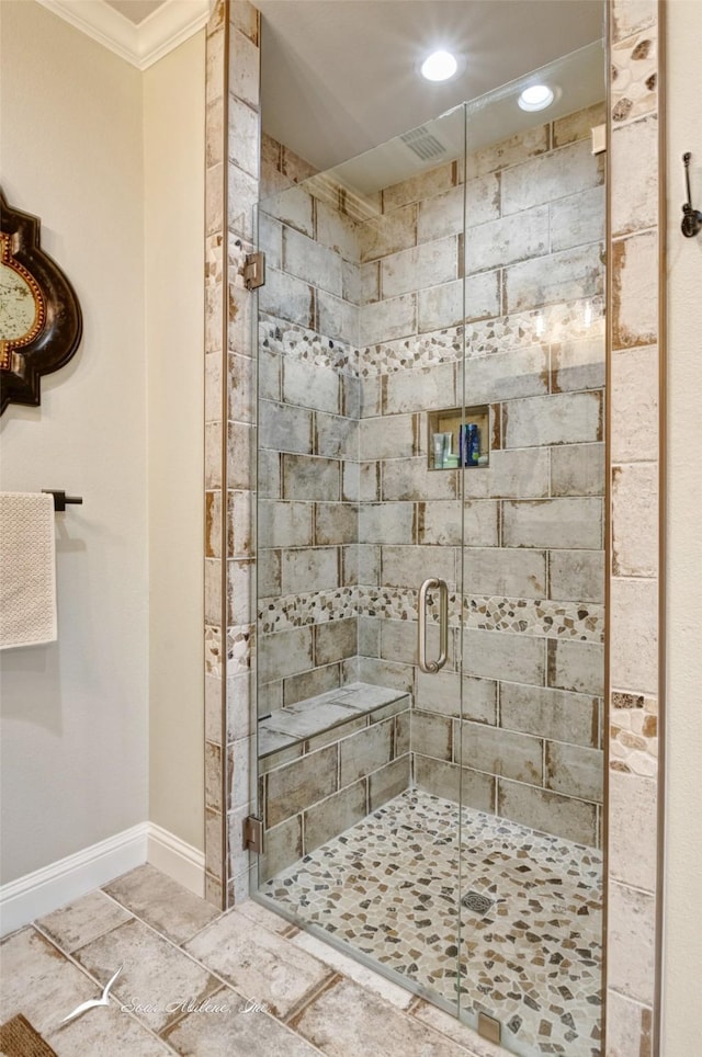 bathroom featuring ornamental molding and a shower with shower door