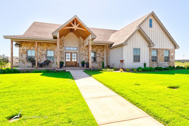 view of front facade with french doors and a front lawn