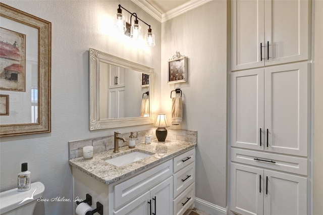 bathroom featuring crown molding, vanity, and toilet