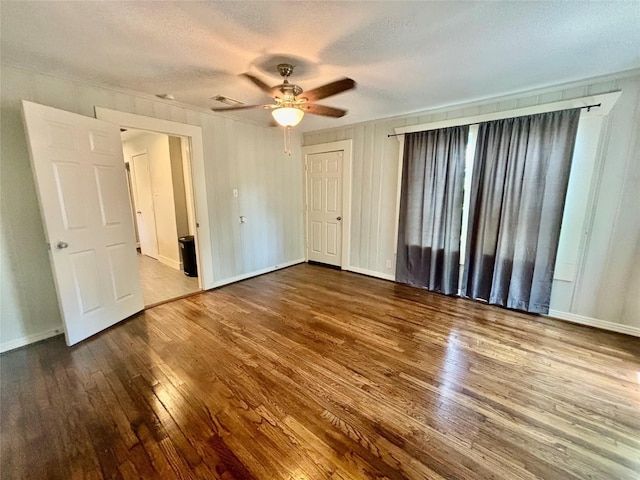 interior space featuring wood-type flooring, a textured ceiling, and ceiling fan