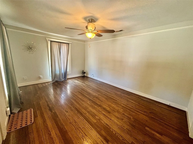 empty room with dark hardwood / wood-style floors, ceiling fan, and a textured ceiling