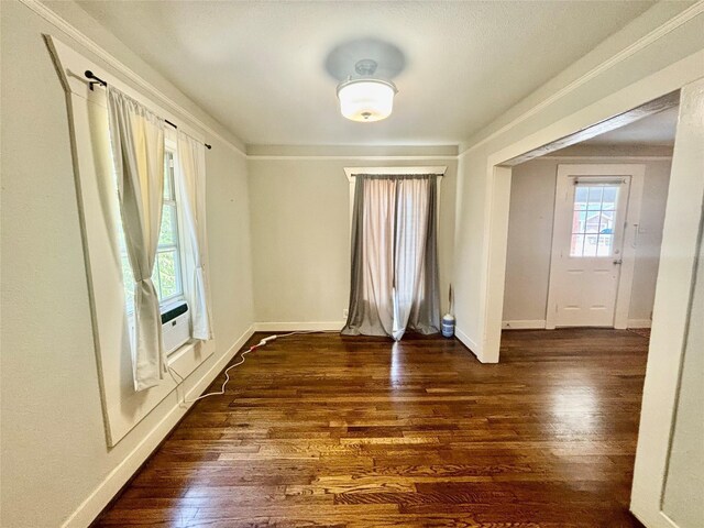 empty room featuring dark hardwood / wood-style flooring and cooling unit