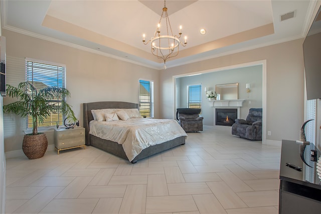 bedroom with a notable chandelier, crown molding, and a tray ceiling