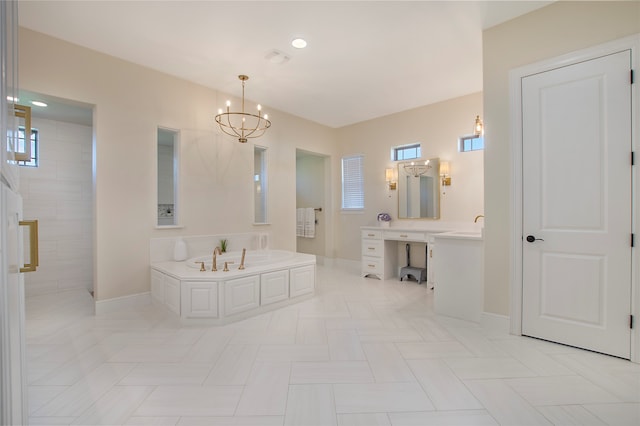 bathroom with plenty of natural light, independent shower and bath, vanity, and an inviting chandelier