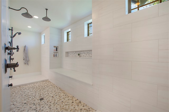 bathroom with plenty of natural light and tiled shower