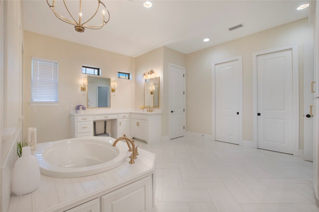 bathroom with tile patterned flooring, vanity, a bathtub, and a chandelier