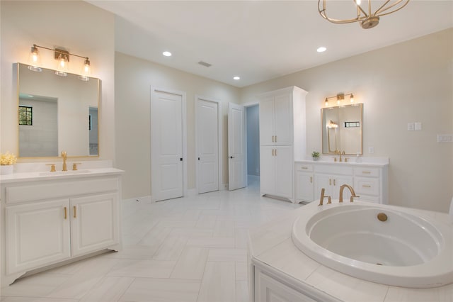 bathroom featuring a bath, vanity, and an inviting chandelier