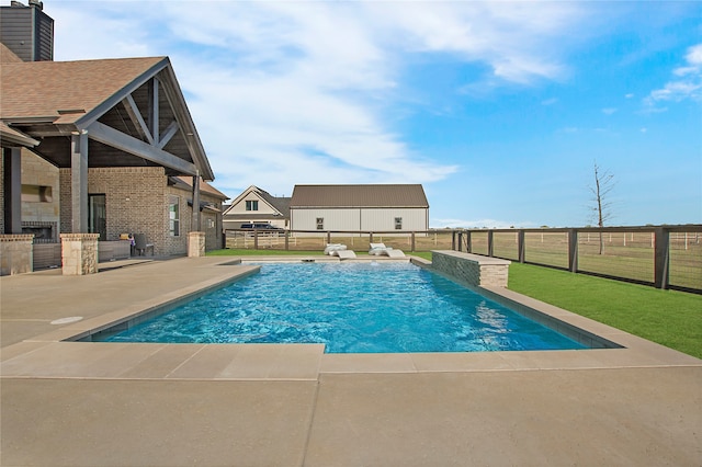 view of pool featuring a lawn and a patio