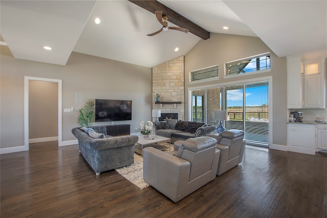 living room featuring ceiling fan, dark hardwood / wood-style flooring, beamed ceiling, high vaulted ceiling, and a fireplace