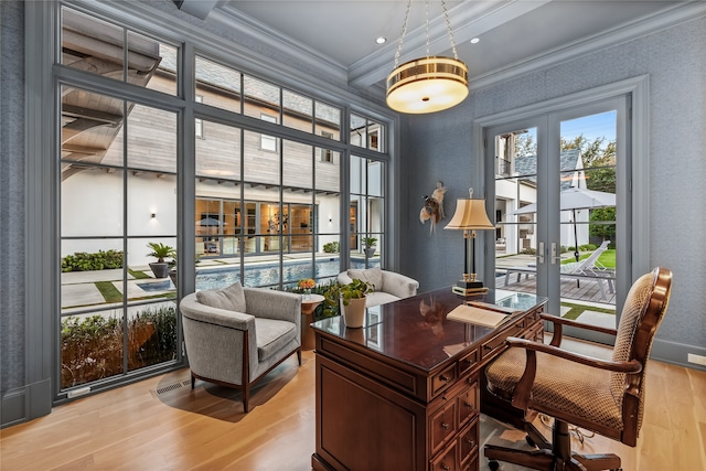 office with light wood-type flooring, crown molding, and french doors