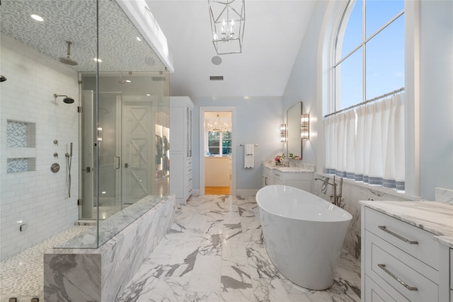 bathroom featuring separate shower and tub, a wealth of natural light, vanity, and vaulted ceiling