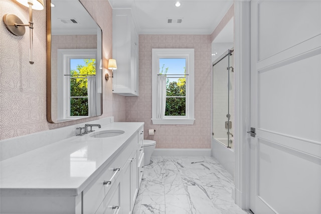 full bathroom featuring toilet, vanity, ornamental molding, and tub / shower combination