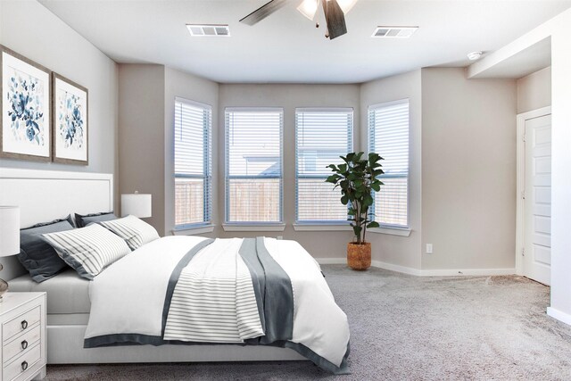 carpeted bedroom featuring ensuite bathroom and ceiling fan