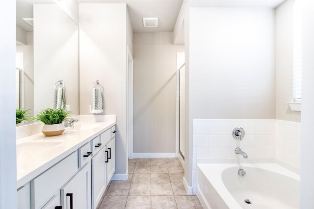 bathroom with tile patterned flooring, vanity, and plus walk in shower