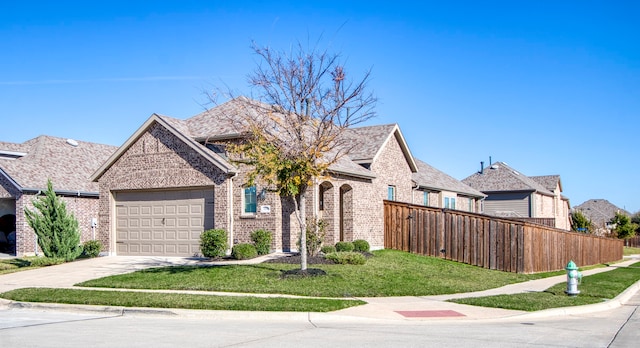 view of front of house with a garage and a front lawn