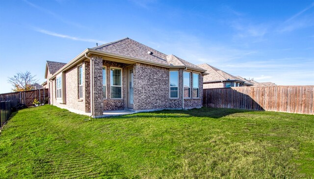 rear view of property with a yard