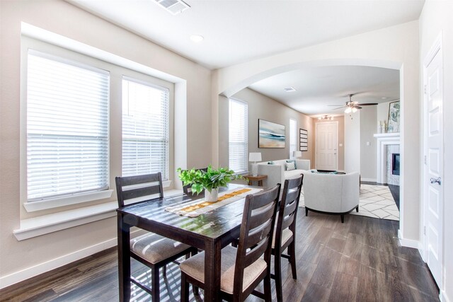 kitchen featuring appliances with stainless steel finishes, dark wood-type flooring, sink, stone counters, and white cabinets