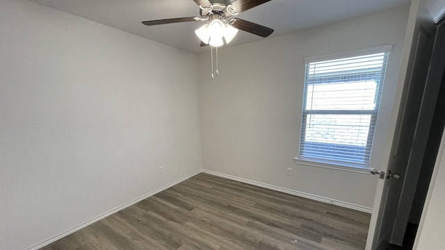 spare room with ceiling fan and dark wood-type flooring