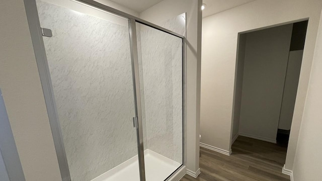 bathroom featuring hardwood / wood-style flooring and an enclosed shower