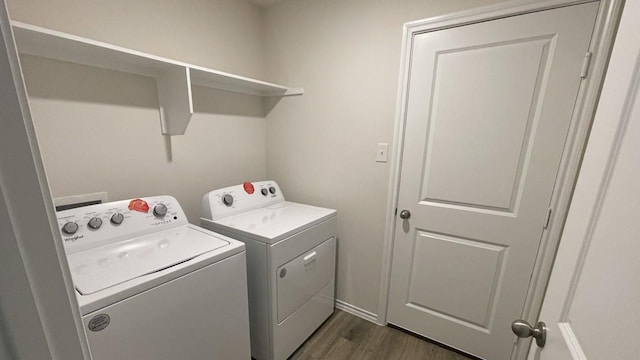 clothes washing area featuring washer and dryer and dark hardwood / wood-style floors