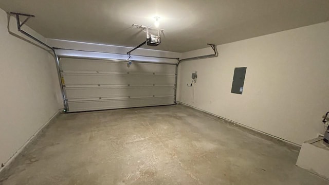 garage with electric panel and a garage door opener