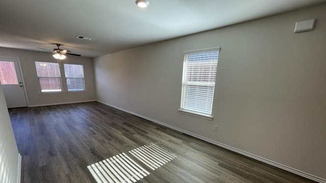 empty room featuring ceiling fan and dark hardwood / wood-style flooring