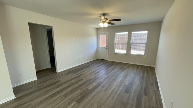 empty room featuring ceiling fan and dark hardwood / wood-style flooring