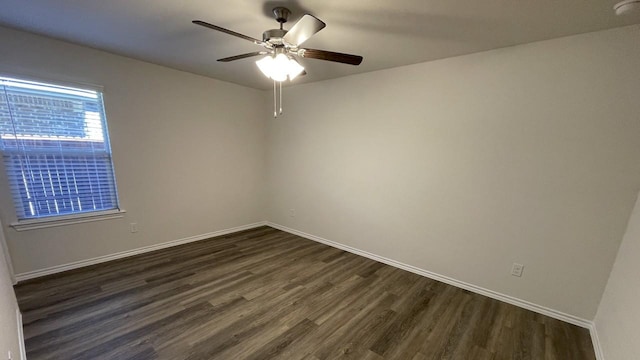 unfurnished room with ceiling fan and dark hardwood / wood-style floors