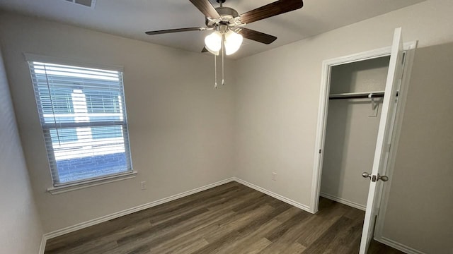 unfurnished bedroom featuring a closet, ceiling fan, and dark hardwood / wood-style floors