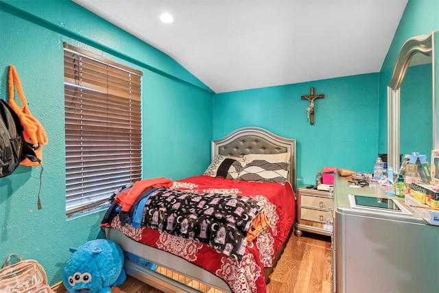 bedroom featuring hardwood / wood-style flooring and lofted ceiling