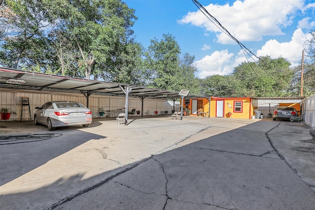 view of parking / parking lot featuring a carport