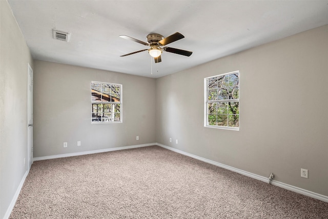 spare room featuring ceiling fan, plenty of natural light, and carpet floors