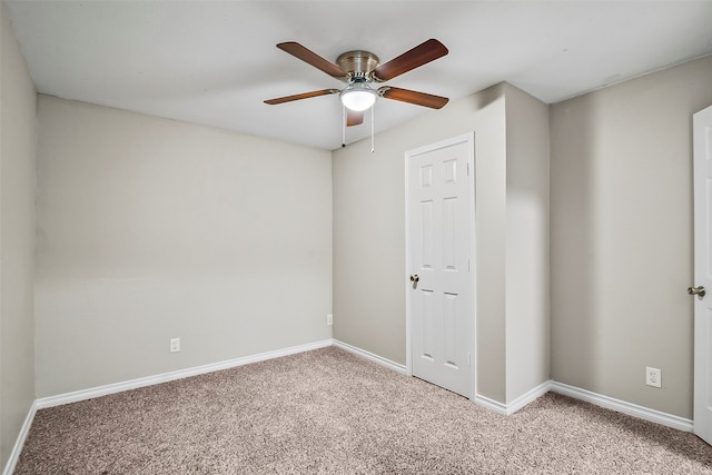 spare room featuring ceiling fan and carpet