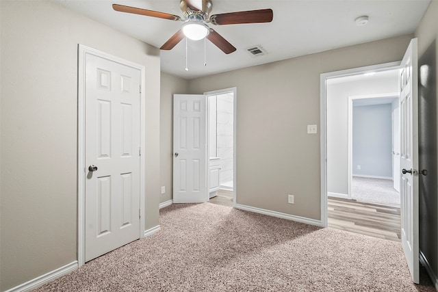 unfurnished bedroom featuring ceiling fan and light colored carpet