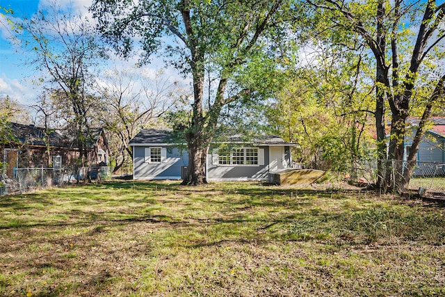 back of property featuring a lawn